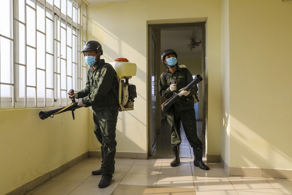 Staff spray disinfectant at a dormitory in Ho Chi Minh city for for the city to use it as centralized facility to quarantine those coming to Vietnam from areas hit by Covid-19, March 18, 2020. Photo by VnExpress/Quynh Tran